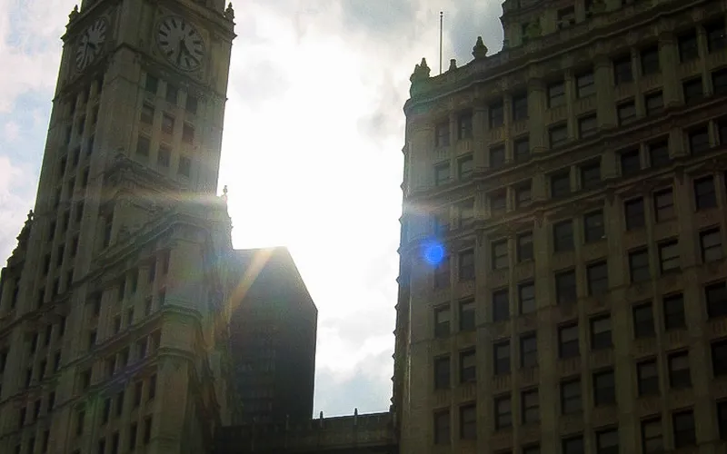 The sun shines behind the Wrigley Building